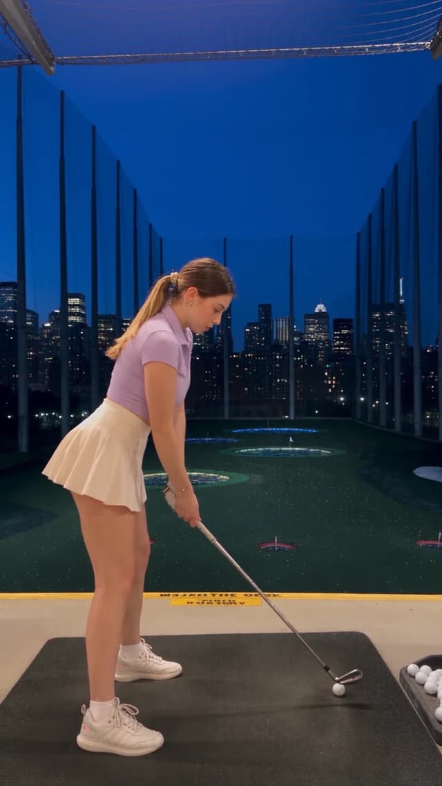 Celine Burke: Golf / Lavender polo / Floodlit rooftop range